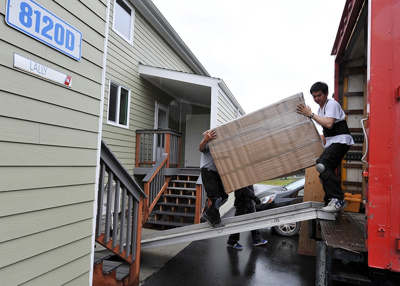 Project-basing of housing choice vouchers (men loading furniture into a truck)