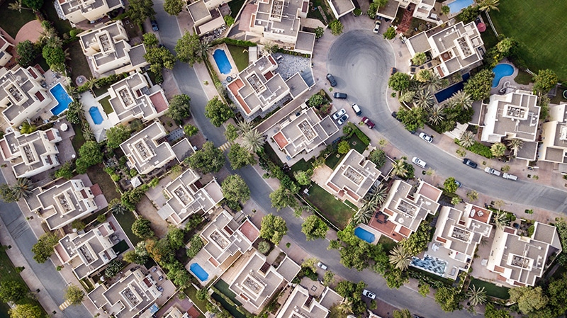 The pros and cons of large-scale, small-scale, and scattered-site development (aerial view of housing complex)