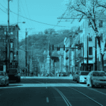 Streetscape with cars and trees, blue tint