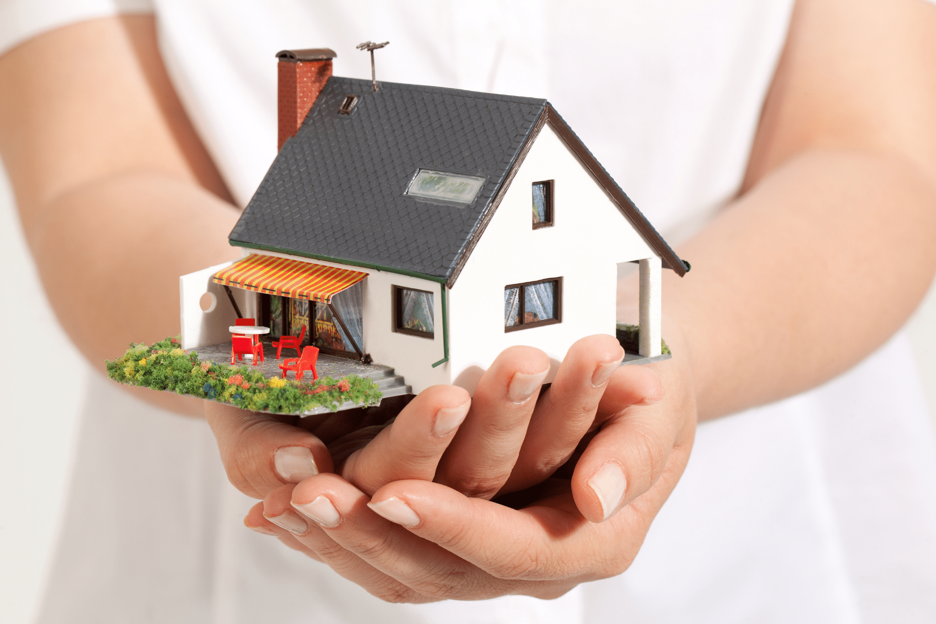 A picture of a young person holding a house is used to illustrate the concept of unhoused minors in rural Missouri