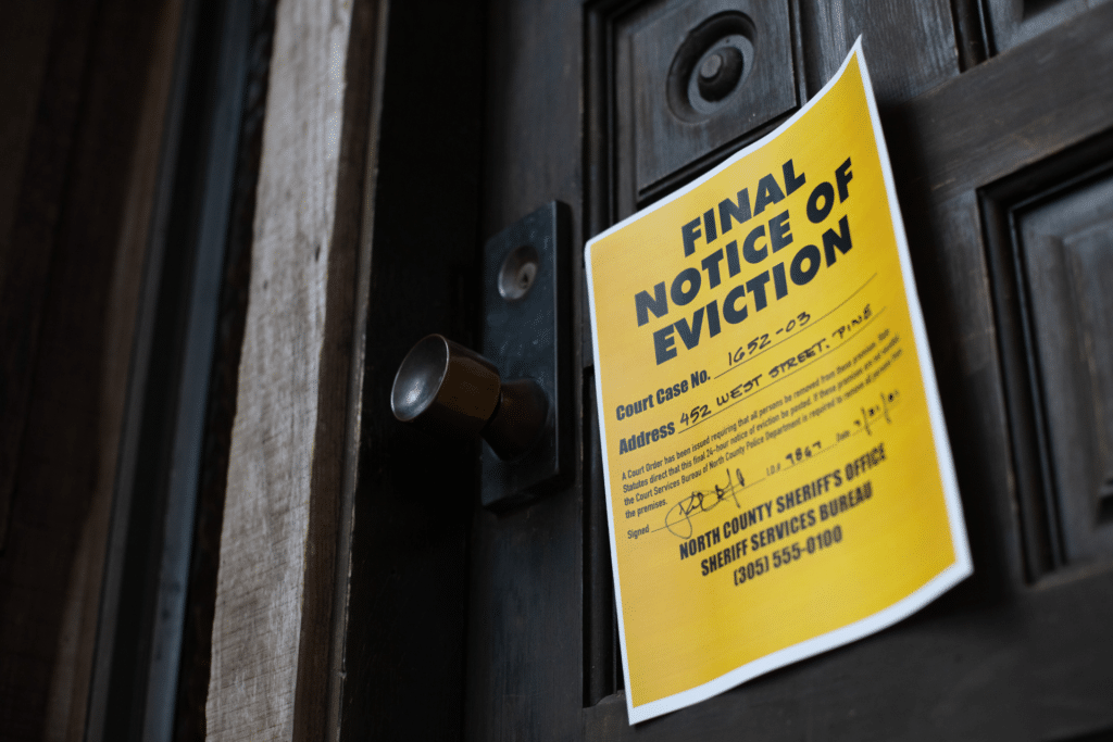 Notice of eviction on a door is shown to illustrate "good cause" eviction policies