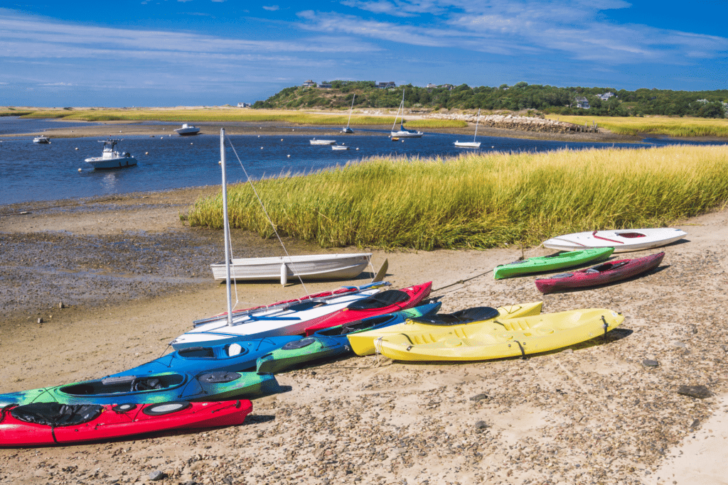 Kayaks on a beach in Cape Cod are shown. Cape Cod is a popular seasonal town during the summer months.