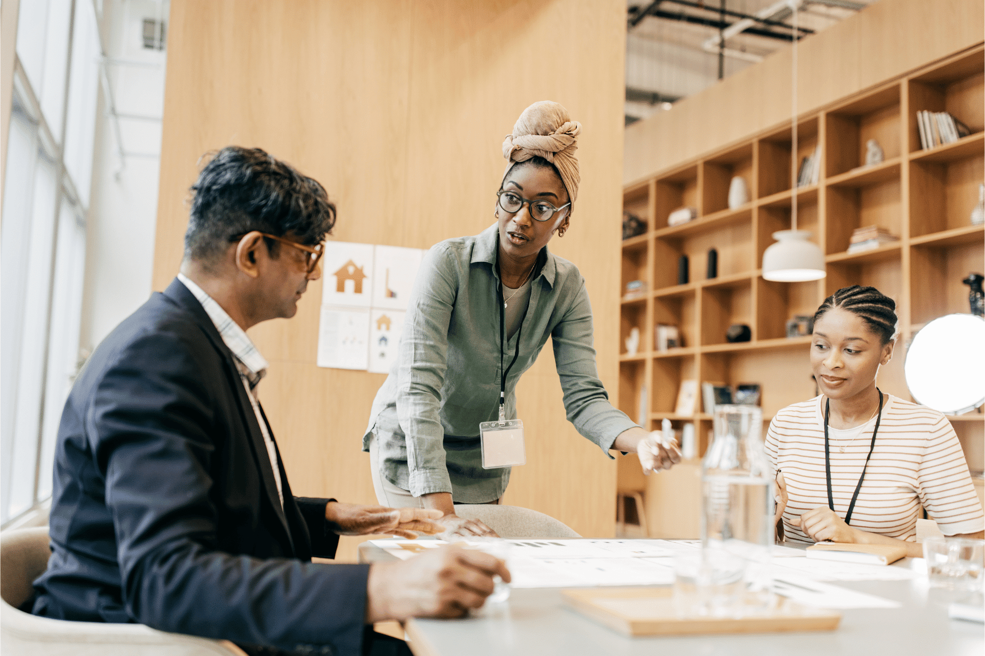 A group of racially diverse individuals gathered around a table looking at chart is used to illustrate the concept of using data to advance equity